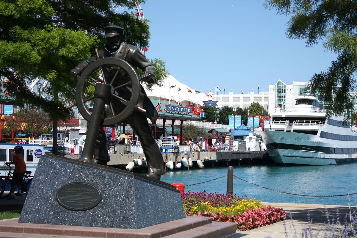 Navy Pier in Chicago with captain steering the helm on a boat