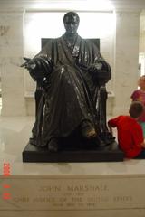 Statue of John Marshall in front of a classical building with columns