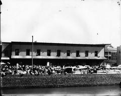 Traditional Chinese dragon procession in Honolulu's Chinatown with buildings and people along the river