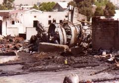 Wreckage of PSA Flight 182 crash site with emergency responders and damaged vehicles