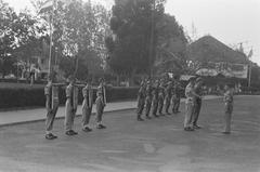 Black and white photograph of a military guard change at Oranje-Nassauboulevard and Burgemeester Bisschopsplein in Menteng, Batavia, July 1946