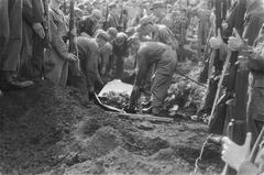 Black and white photo of a gravesite with military personnel at a funeral ceremony in Batavia, Dutch East Indies, 1946