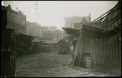Historic buildings on North Clark Street in Chicago with horse-drawn carriages at noon in 1913
