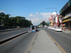 View of Old Capitol Site along Commonwealth Avenue featuring City Mall and PhilCoa footbridge near San Vicente and U.P. Village in Quezon City