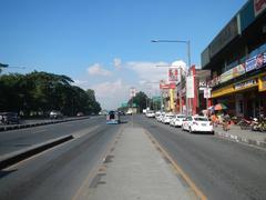 View of Old Capitol Site and City Mall along Commonwealth Avenue in Quezon City with PhilCoa footbridge and nearby San Vicente and UP Village areas
