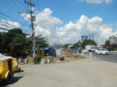 Commonwealth Avenue and Barangay Holy Spirit in Quezon City with San Jose Ang Tagapagtanggol Parish Church and flood control infrastructure
