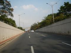 Batasan Hills area in Quezon City featuring the intersection of Batasan Road and Commonwealth Avenue with buildings and greenery