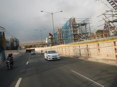 Intersection of Batasan Road and Commonwealth Avenue in Batasan Hills, Quezon City, Metro Manila with urban buildings and traffic
