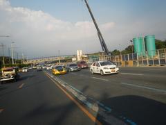 Street view of Commonwealth Avenue corner Batasan Road in Batasan Hills, Quezon City, Metro Manila with traffic and buildings
