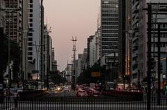 Sunset view over Avenida Paulista with city skyline and lit streetlights