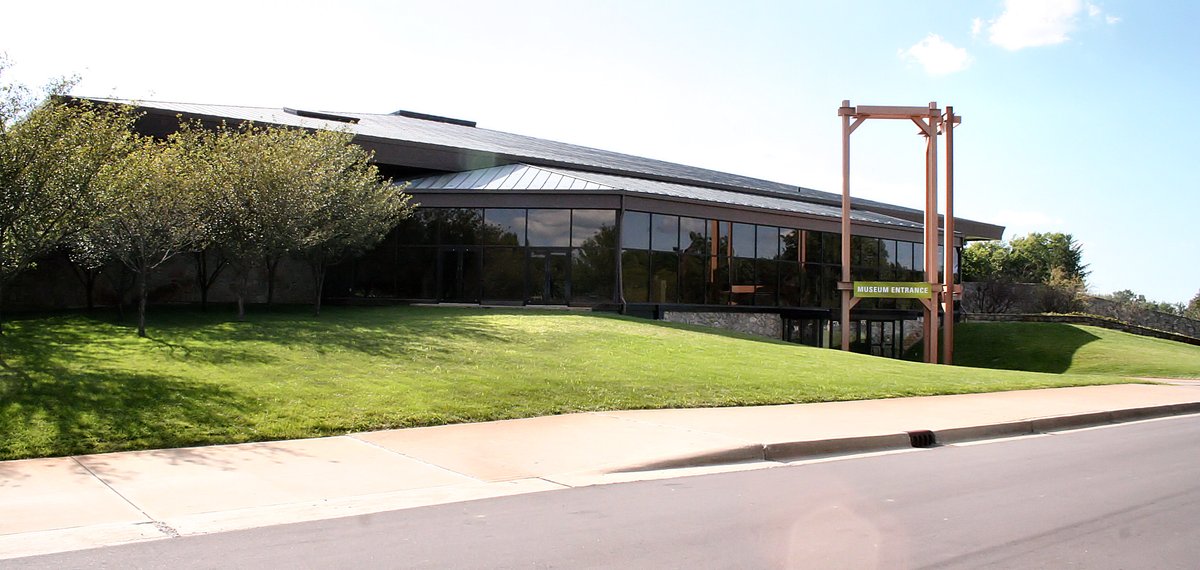 Exterior view of Conner Prairie Museum with historic buildings and green lawn