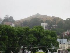 View of Corona Heights park with rocky hills and greenery under blue sky