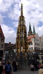 Schöner Brunnen ornate fountain in Nuremberg Germany with intricate golden decorations and sculptures
