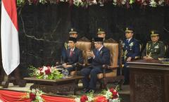 Indonesian President Joko Widodo sitting in the seat of former President Susilo Bambang Yudhoyono during inaugural ceremonies in Jakarta