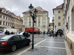 Snow-covered Prague street with historical buildings and tram tracks in winter