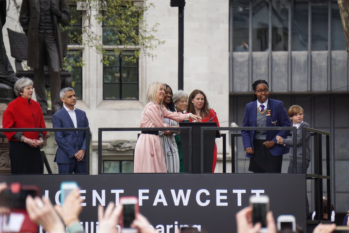 Statue unveiling ceremony featuring Theresa May, Sadiq Khan, Caroline Criado-Perez, and children