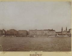 Historical view of Pesti szállodasor in Budapest from the Duna River, showing buildings including Első Magyar Általános Biztosító Intézet headquarters, Grand Hotel Hungária, Hotel Bristol, and Nagyboldogasszony Orthodox Cathedral, 1912