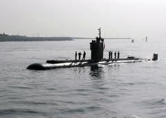 Crew members aboard the USS Dolphin submarine pulling into San Diego harbor