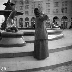 People watching a solar eclipse at Kauppatori near Havis Amanda statue