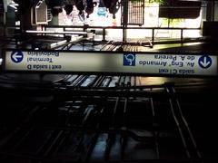 Mezzanine area inside Jabaquara Station with passengers and staircases