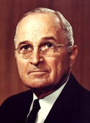 Color portrait photograph of President Harry S. Truman seated in a chair