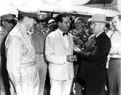 President Harry S. Truman presenting the U.S. Medal of Merit to Ambassador John J. Muccio with General Douglas MacArthur