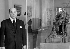 Sculptor Felix De Weldon standing next to the plaster maquette of the Iwo Jima Monument in the Garden Room of the Harry S. Truman Presidential Library