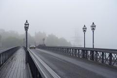 Skeppsholmsbron bridge over water in Stockholm with cityscape and cloudy sky