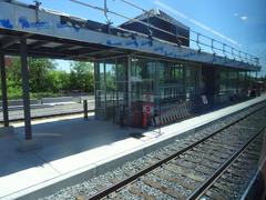 View through left window of train traveling from Union to Pearson stations, urban buildings and sky visible