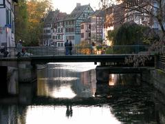 Reflection of Strasbourg buildings in water at sunset