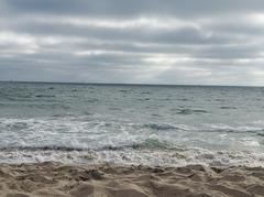 Pacific Ocean waves crashing onto Dockweiler Beach sandy shore