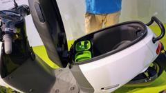 Gogoro 2 Series white model with opened rear seat showing two Gogoro energy batteries