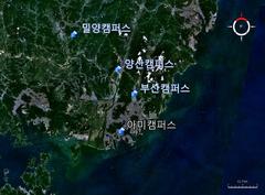 Satellite image showing the location of Pusan National University campus using Landsat7 with an arrow indicator