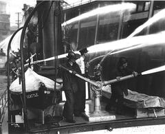 Firefighters on fireboat battling Grand Trunk Pacific Dock fire in Seattle 1914