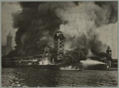 Grand Trunk Pacific dock on fire in Seattle, July 30, 1914 with fireboat in foreground