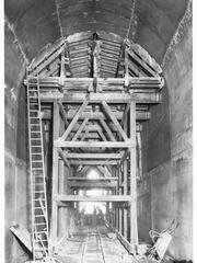 Construction of Eden Hills railway tunnel with workers and machinery