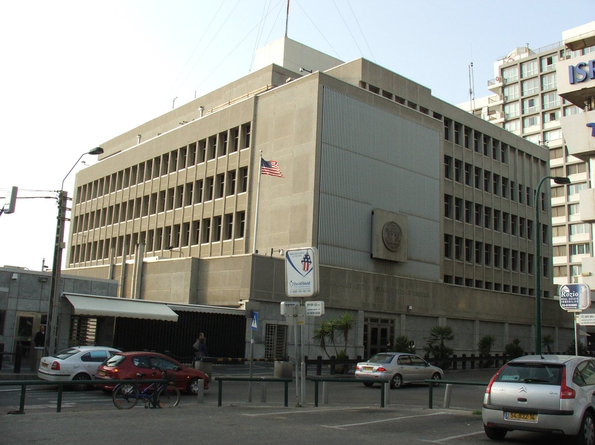 US Embassy Tel Aviv building exterior with American and Israeli flags