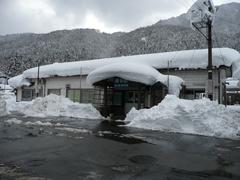 Winter view of Inotani Station building covered in snow