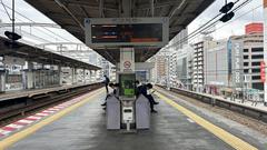 Hanshin Noda Station platform with train tracks and overhead structures in Japan