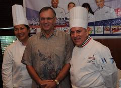 Cooking demonstration featuring American, Filipino, and Indonesian chefs collaborating in a culinary event under the USDA Council of Chefs program