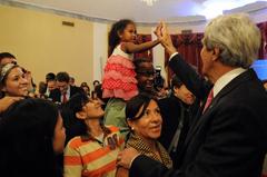 U.S. Secretary of State John Kerry high-fiving daughter of U.S. Embassy Manila employee