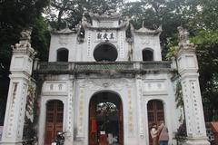 Quan Thanh Temple entrance in Hanoi with traditional Vietnamese architecture and vibrant decorations