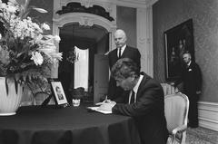 Dutch Prime Minister Ruud Lubbers signing condolence book for assassinated Swedish Prime Minister Olof Palme in The Hague with Swedish Ambassador Danelius behind him