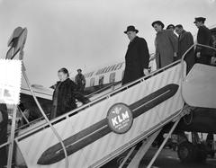 Swedish Prime Minister Tage Erlander arriving at Schiphol Airport with Olof Palme walking behind him, March 6, 1957