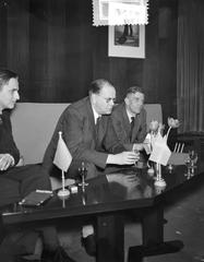 Swedish Prime Minister Tage Erlander arriving at Schiphol Airport in 1957, standing with Olof Palme and Alfred Mozer during a press conference