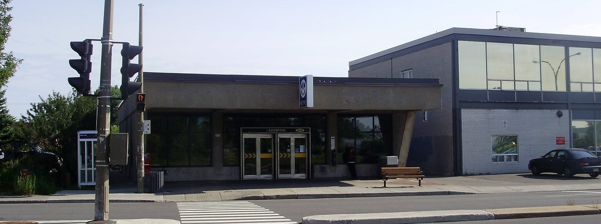 Assomption metro station platform with trains and passengers in Montreal