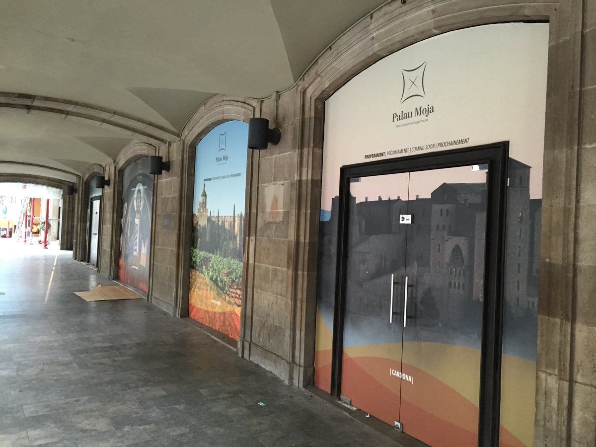 Exterior view of Palau Moja showcasing historic restoration and old shop front