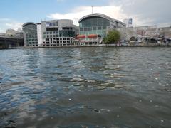 Quezon Bridge Ferry Station on Pasig River in Manila with ferries and city buildings