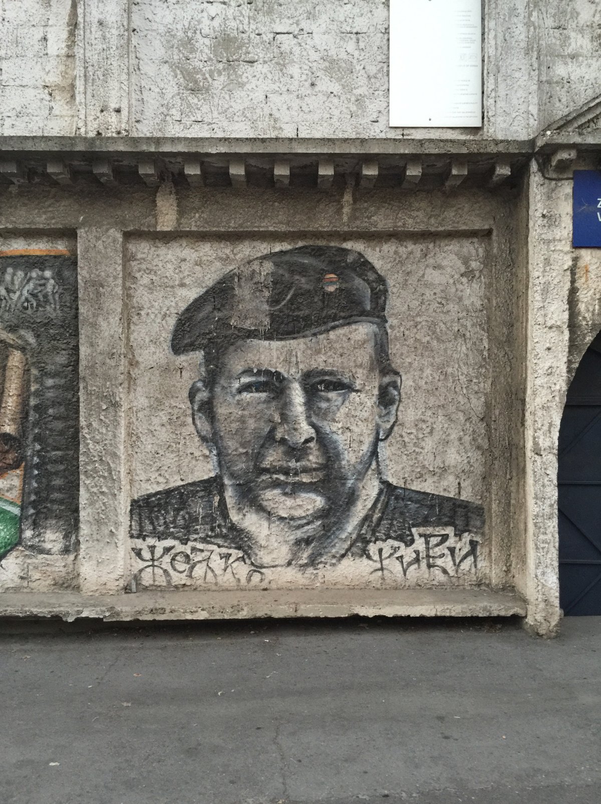 Mural of Željko Ražnatović Arkan on the wall of FK Obilić stadium in Belgrade with Serbian phrase 'Željko lives'