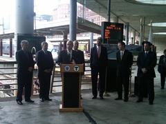 MassDOT Secretary Jeff Mullan, Senator John Kerry, Boston Mayor Thomas Menino, MBTA GM Richard Davey, and state legislators at South Station in Boston